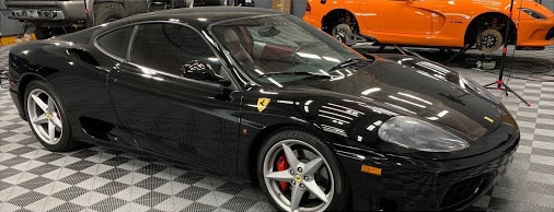Black ferrari with other cars on the background