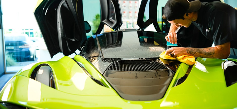Car Detailing Expert Working On Green McLaren 720S Sports Car